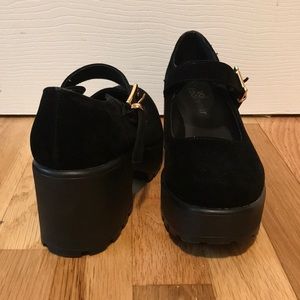 black platform shoes by Koi Footwear